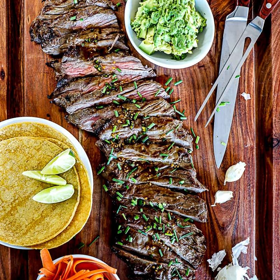 Juicy skirt steak grilling on a barbecue