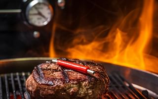 What is the ideal grilling time for a burger on an outdoor gas grill?
